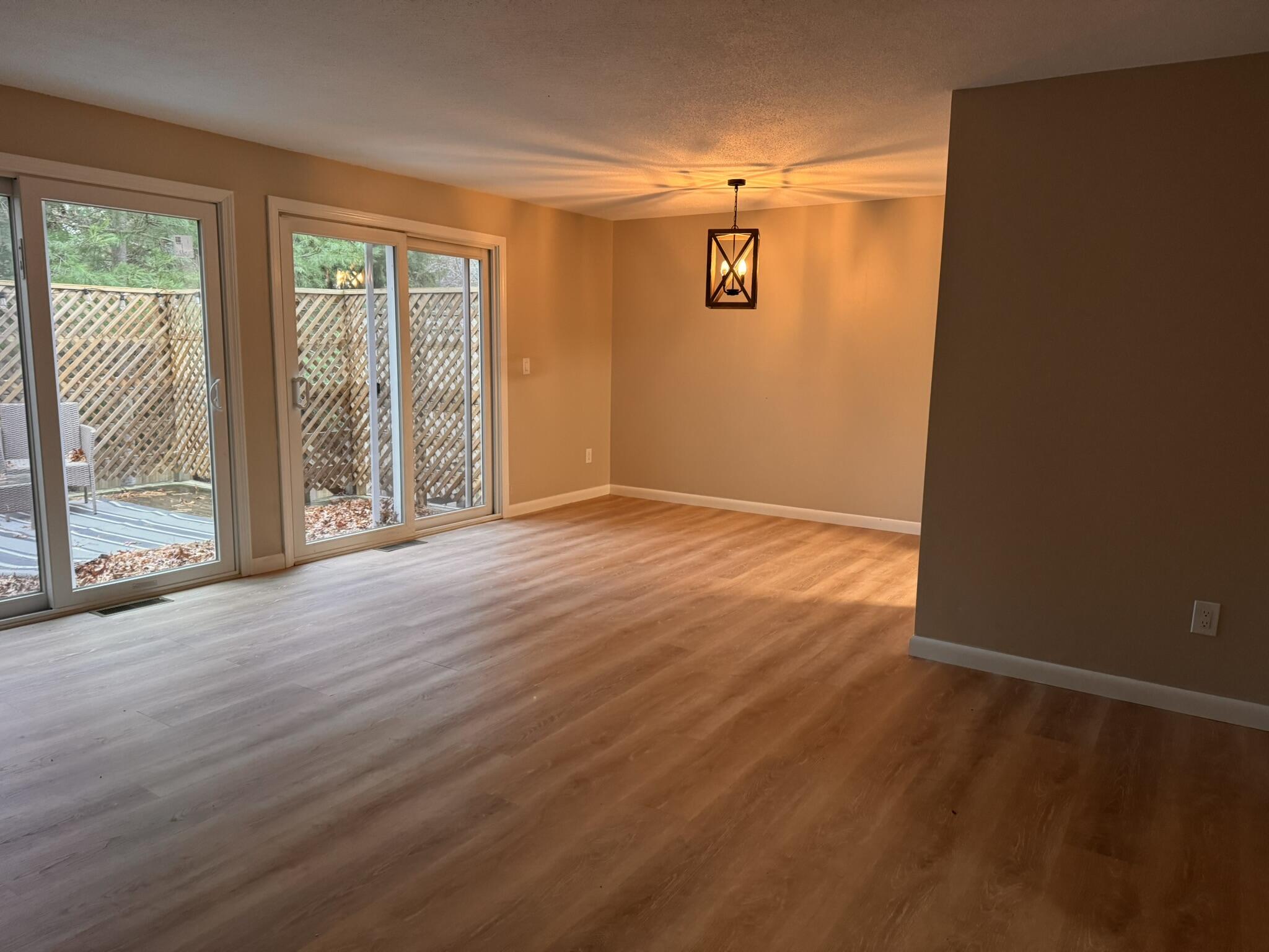 225 SW Meadows, Unit 225 Teaticket, MA 02536 - Photo 5 of 20 an empty room with wooden floor and windows