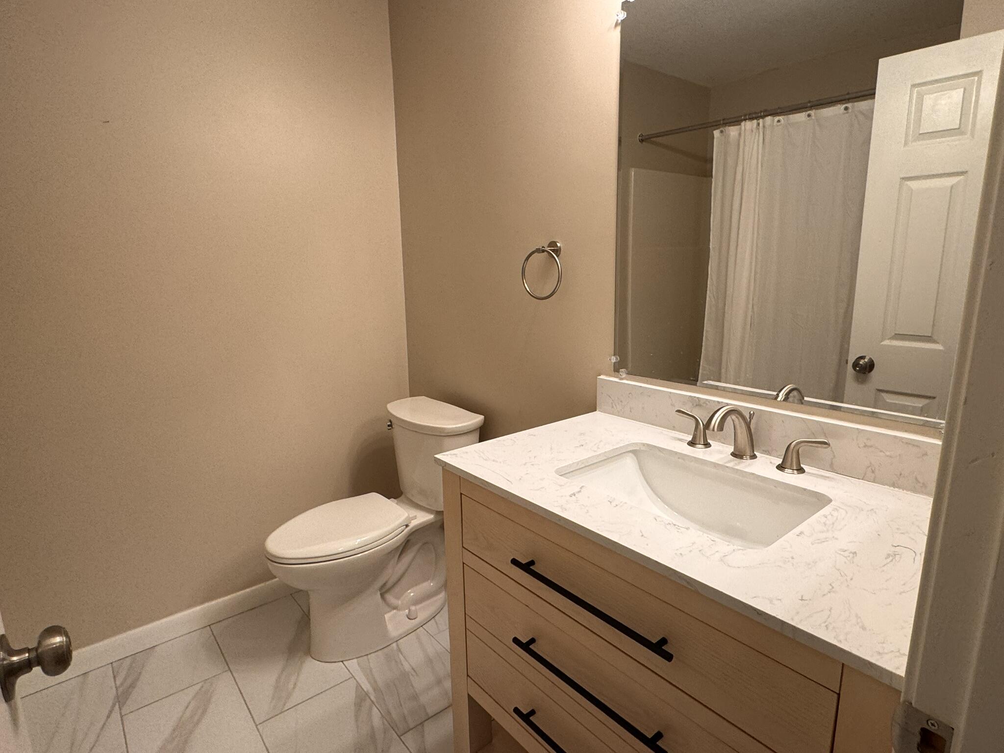 225 SW Meadows, Unit 225 Teaticket, MA 02536 - Photo 10 of 20 a bathroom with a sink toilet and mirror