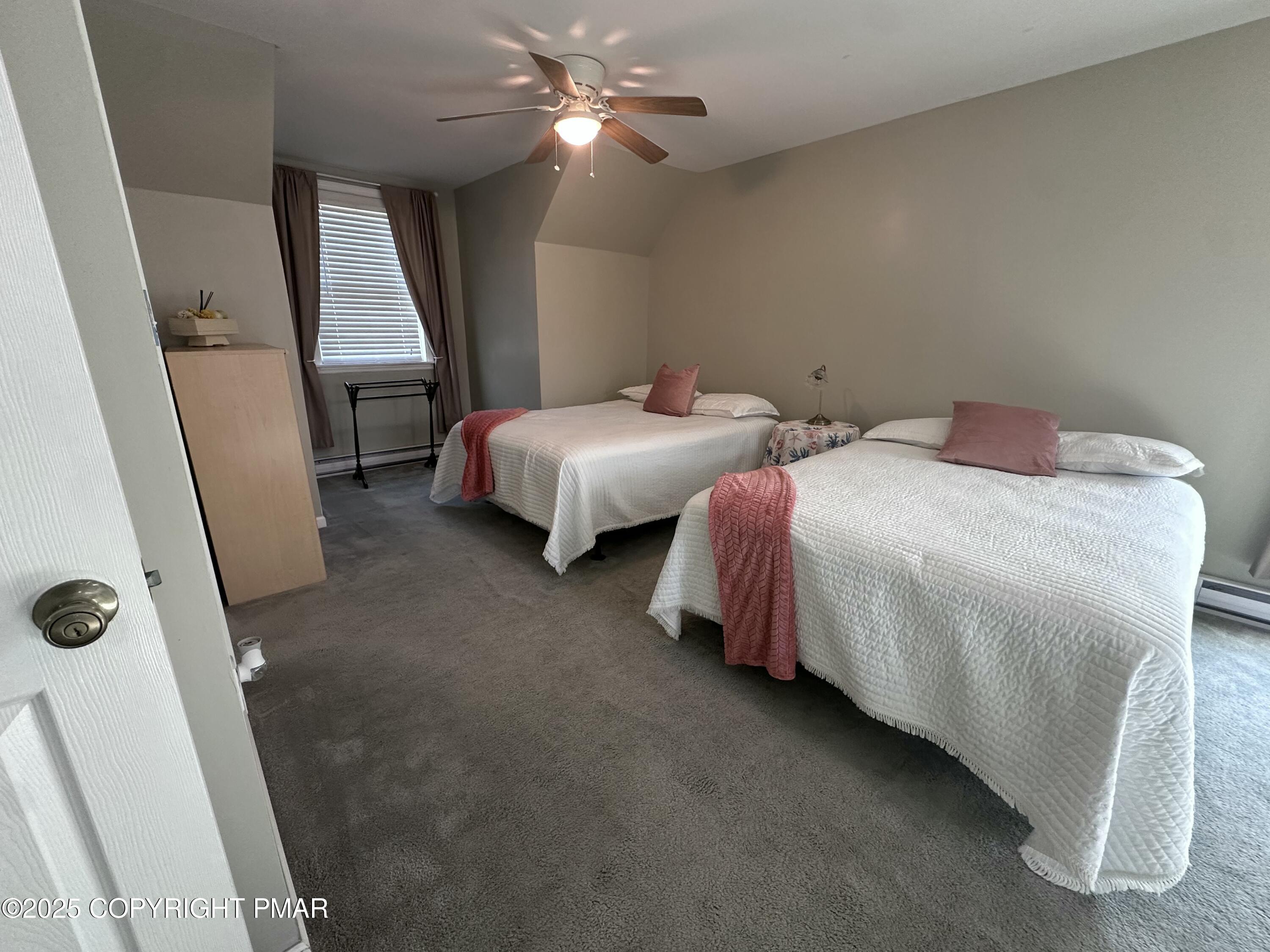 5158 Spring Drive Swiftwater, PA 18370 - Photo 9 of 26 a bedroom with two beds and a chandelier