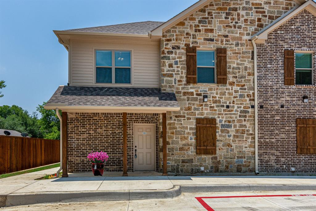 115 West Jones Street, Unit 103 Krum, TX 76249 - Photo 2 of 21 a front view of a house with a garage