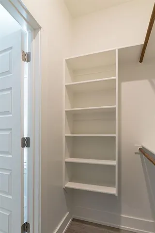 a view of walk in closet with empty racks
