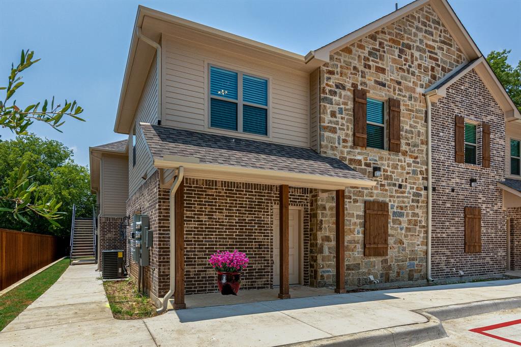 115 West Jones Street, Unit 103 Krum, TX 76249 - Photo 3 of 21 a front view of a house with a potted plant
