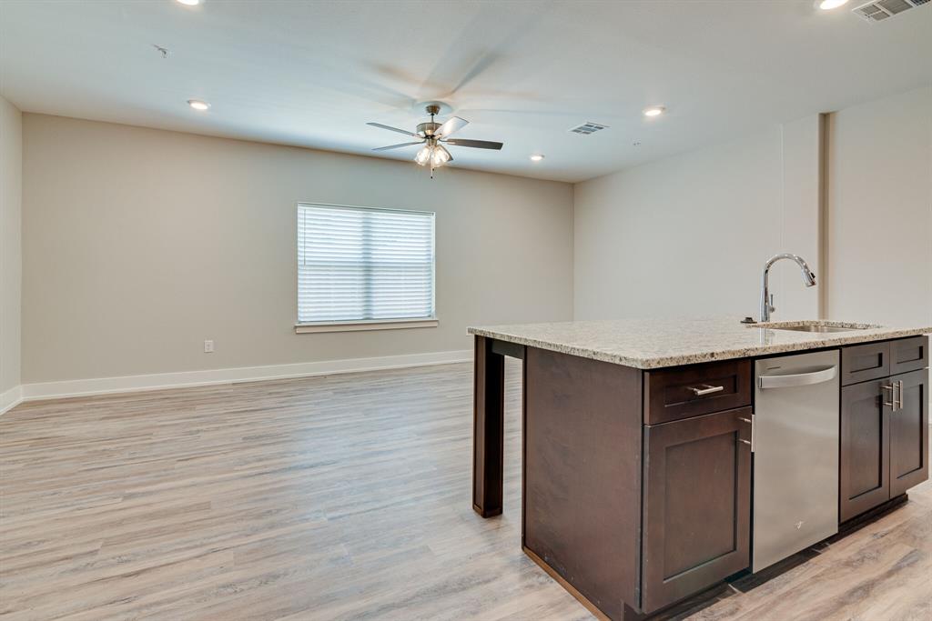 115 West Jones Street, Unit 103 Krum, TX 76249 - Photo 9 of 21 a view of an empty room with wooden floor and a window