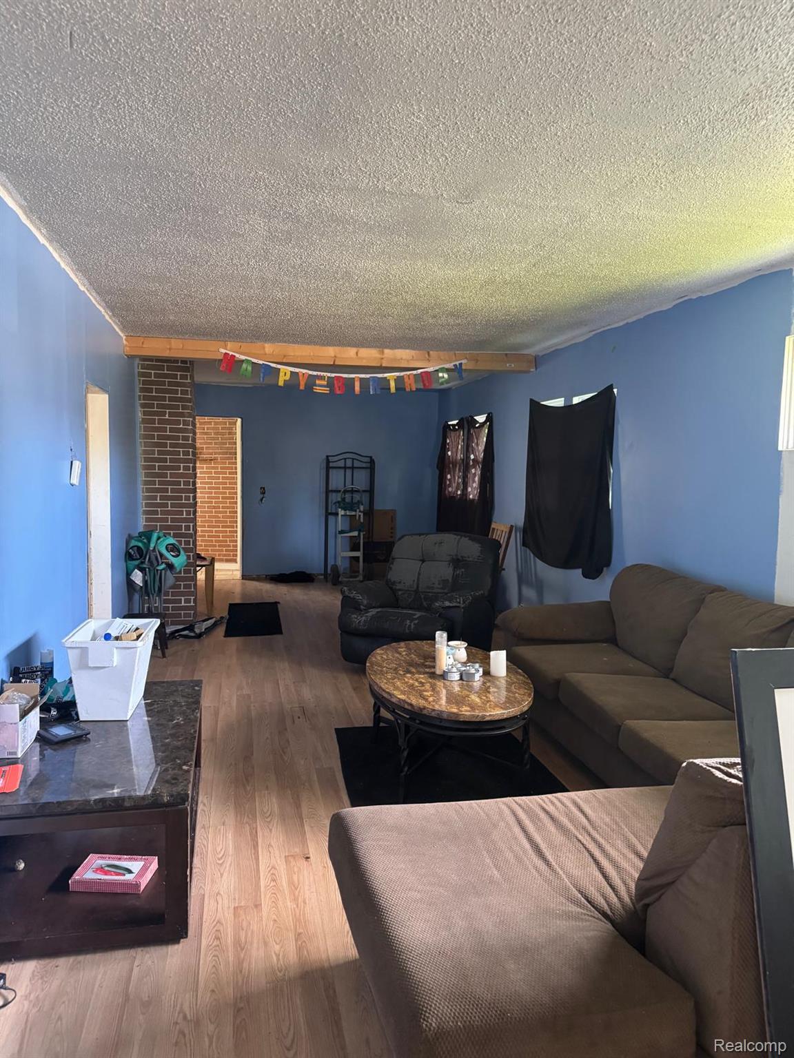 1610 Kent Street Flint, MI 48503 - Photo 5 of 11 Living room with wood finished floors and a textured ceiling