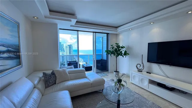 a bedroom with a bed lamp and a large window