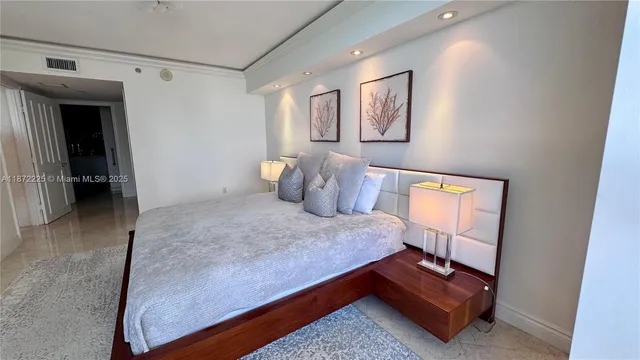 a living room with furniture a flat screen tv and a floor to ceiling window