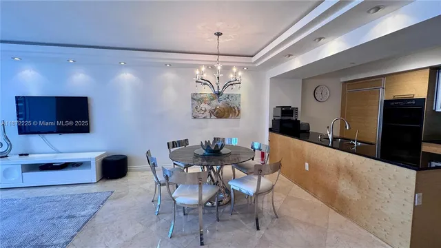 a view of a dining room with furniture and a flat screen tv