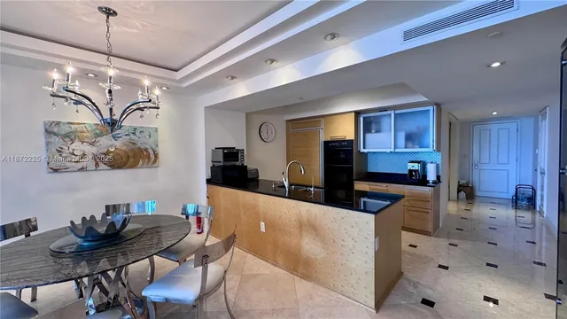 a large kitchen with a table and chairs in it