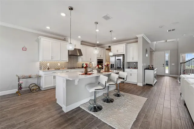 a kitchen with counter space appliances and wooden floor