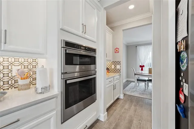 a kitchen with stainless steel appliances a stove microwave and cabinets