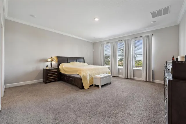 a spacious bedroom with a bed and a couch