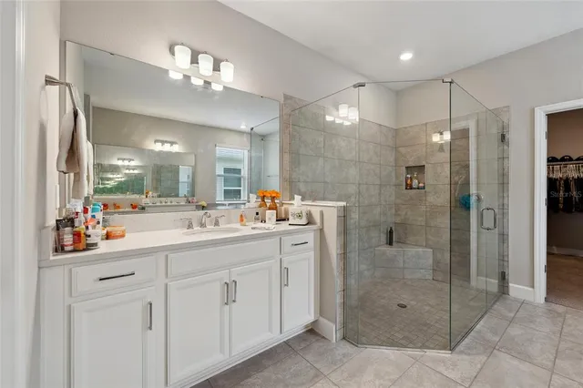 a bathroom with a shower sink and mirror