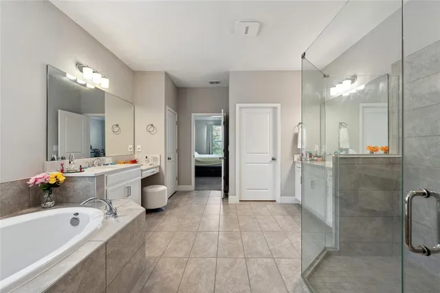 a bathroom with a tub sink shower and mirror