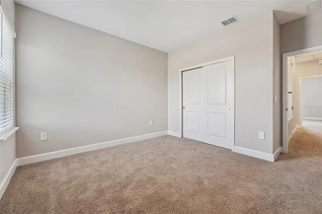 a view of an empty room and closet area