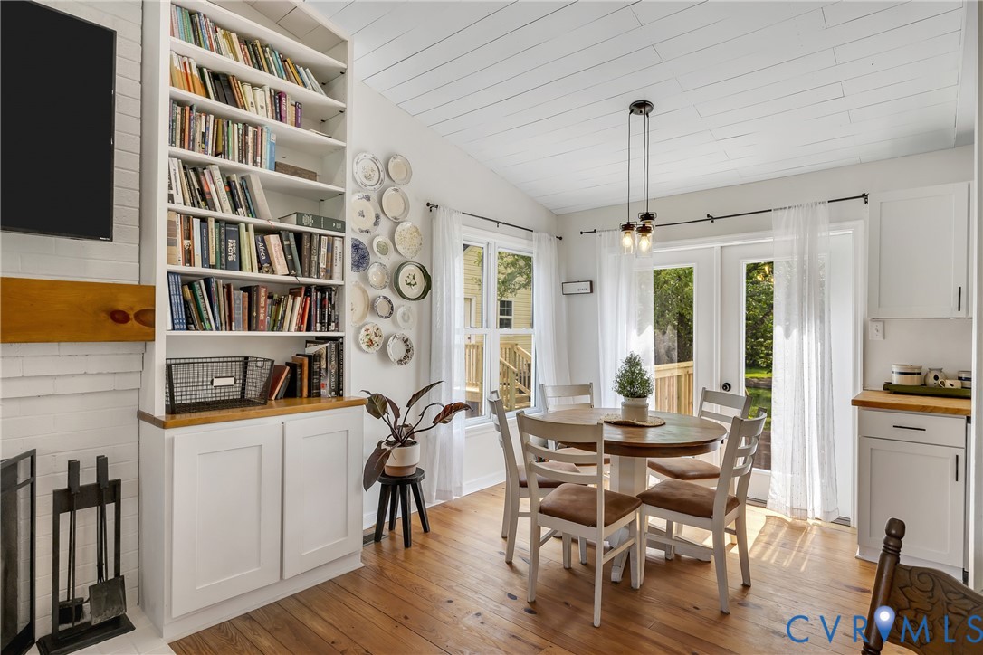 3287 Three Chopt Road Gum Spring, VA 23065 - Photo 7 of 49 a view of a dining room with furniture and a book shelf