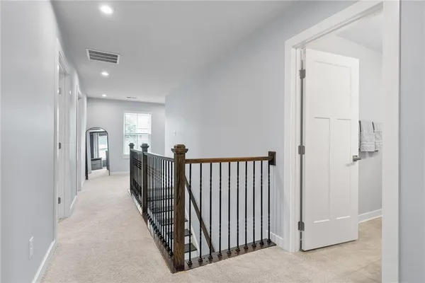 a view of a hallway with closet and a livingroom view
