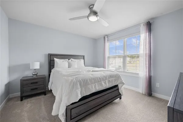 a bed sitting in a bedroom next to a window