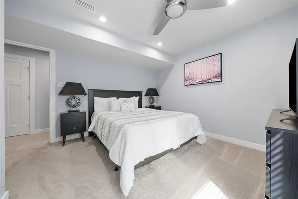 a bedroom with a bed and a tv