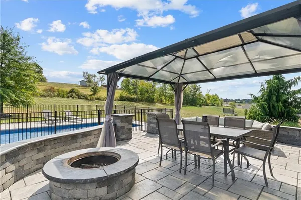 a view of a patio with a table chairs and a backyard