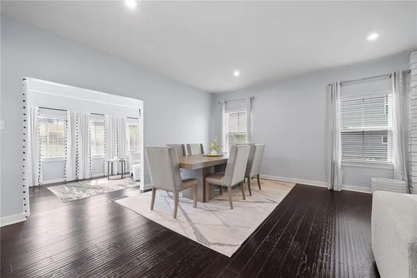 a view of a dining room with furniture and wooden floor