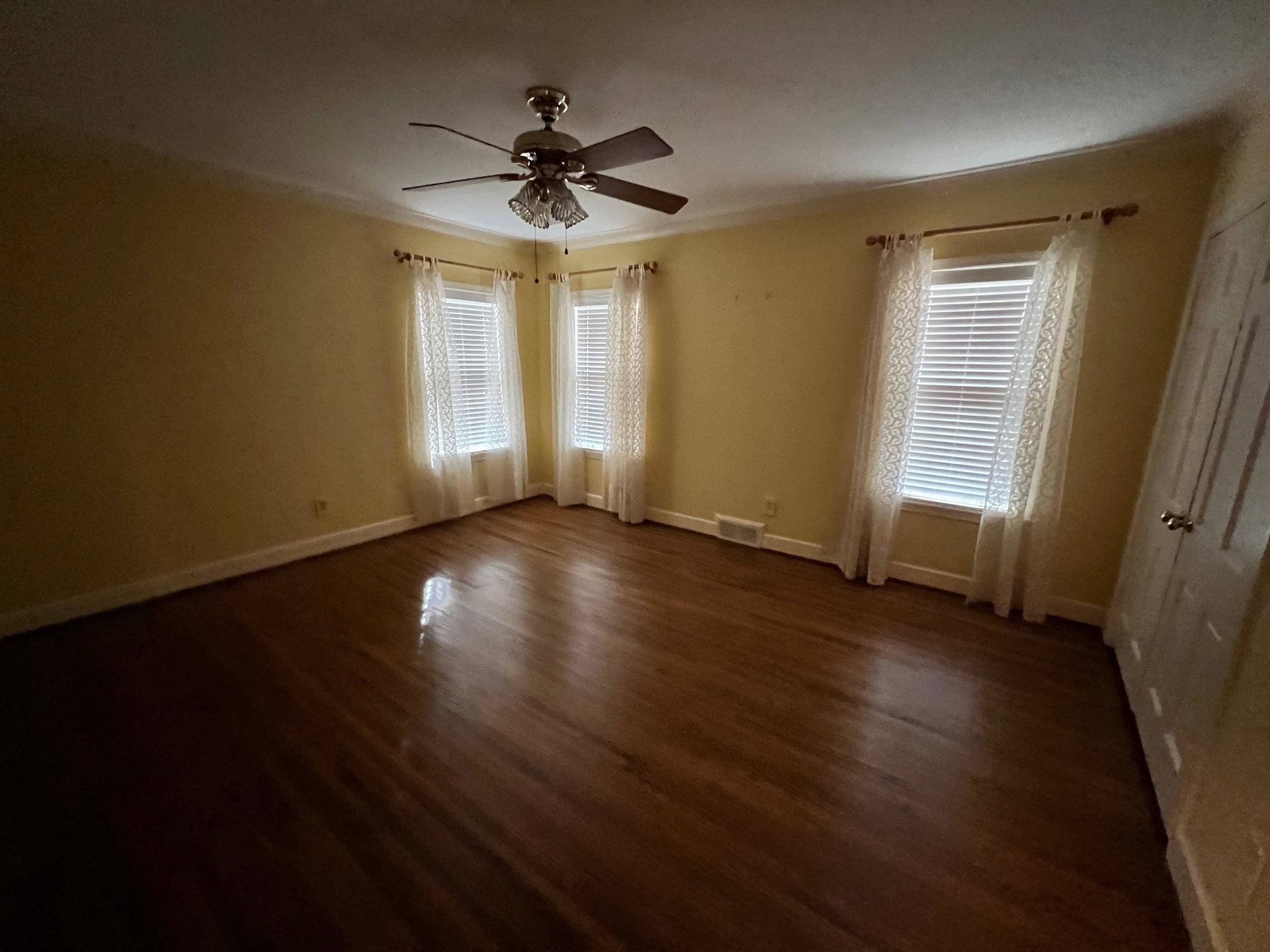 386 Roseland Place Memphis, TN 38111 - Photo 15 of 22 a view of an empty room with wooden floor and a window