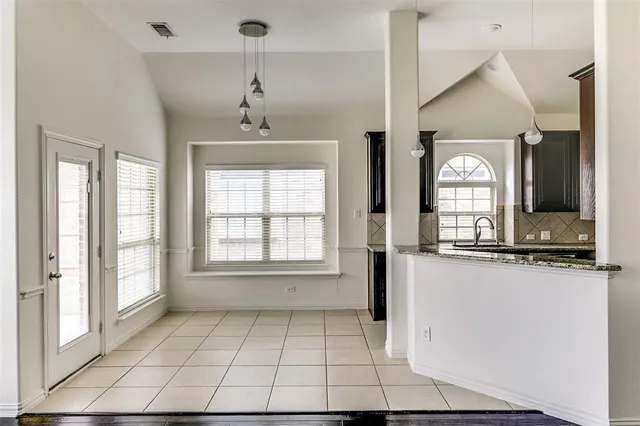 a view of a kitchen with a sink and a window