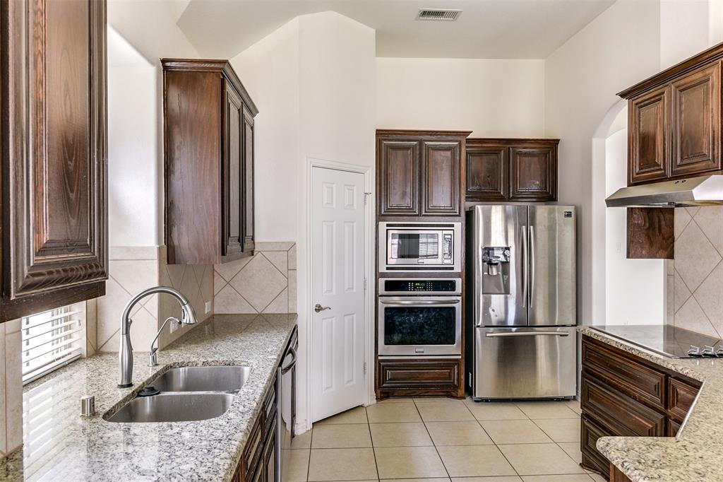 123 Quail Run Road Red Oak, TX 75154 - Photo 15 of 30 a kitchen with stainless steel appliances granite countertop a refrigerator and a sink