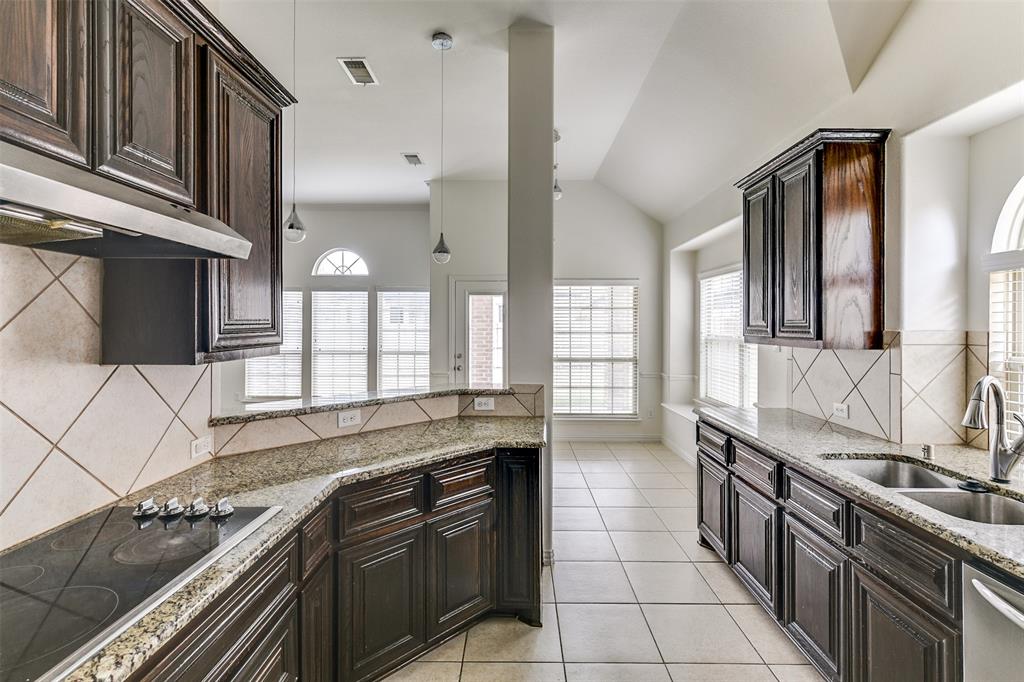 123 Quail Run Road Red Oak, TX 75154 - Photo 17 of 30 a large kitchen with granite countertop a stove and a sink