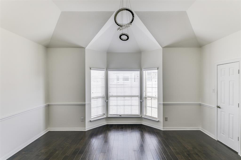 123 Quail Run Road Red Oak, TX 75154 - Photo 18 of 30 a view of an empty room with wooden floor and window