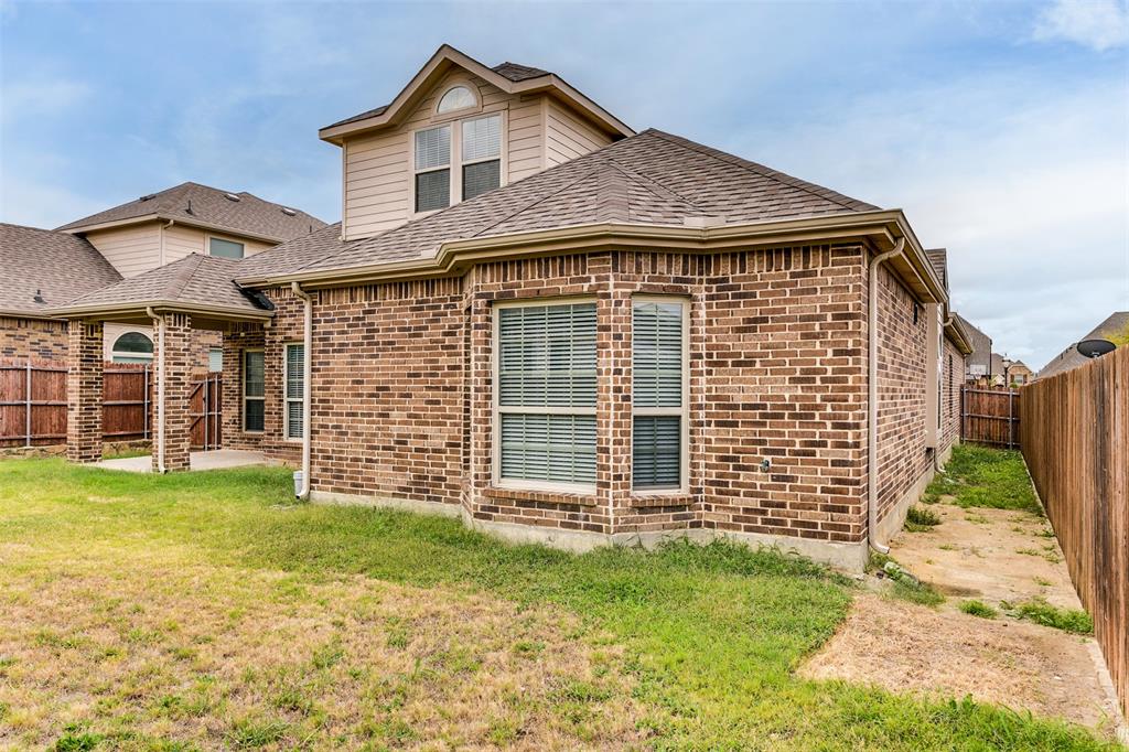 123 Quail Run Road Red Oak, TX 75154 - Photo 30 of 30 a front view of a house with a garden
