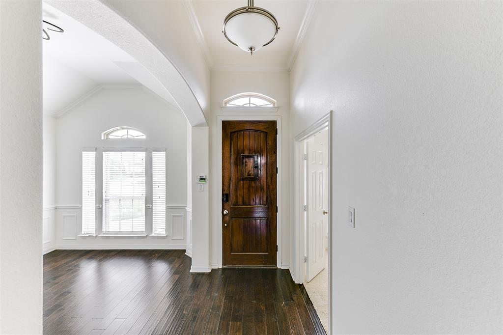 123 Quail Run Road Red Oak, TX 75154 - Photo 4 of 30 an empty room with wooden floor and windows