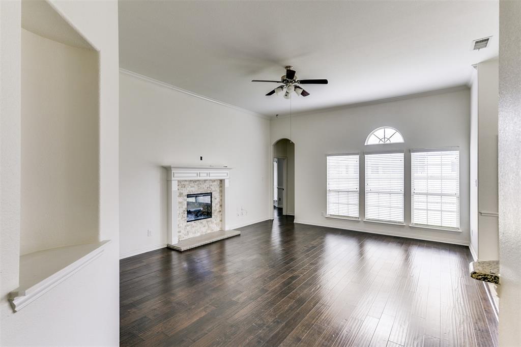 123 Quail Run Road Red Oak, TX 75154 - Photo 10 of 30 a view of an empty room with a window and wooden floor