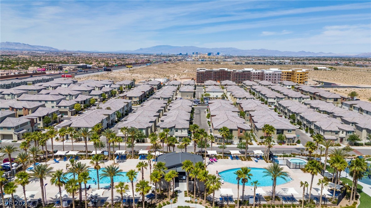 12367 Indigo Montage Road, Unit 3 Las Vegas, NV 89183 - Photo 33 of 33 An aerial perspective showcases a vibrant community with inviting pools and desert landscape.