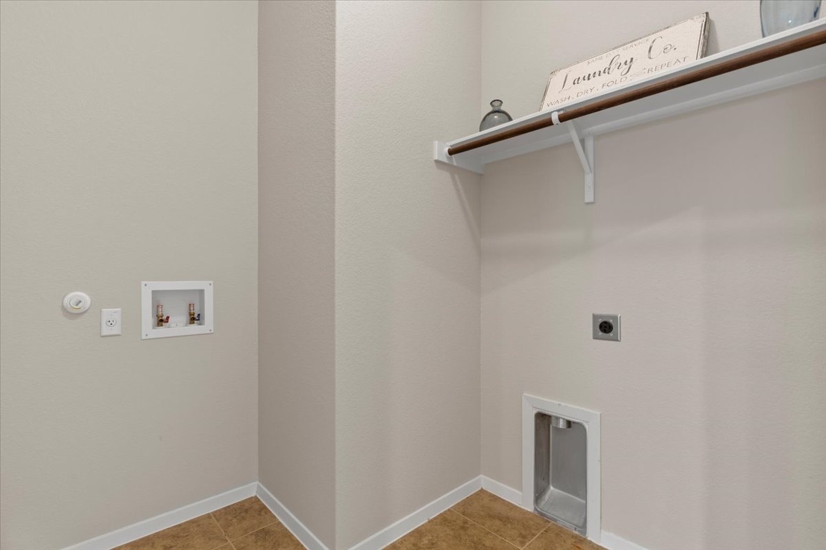 123 Saranac Drive Elgin, TX 78621 - Photo 24 of 27 A full-size laundry room adds everyday practicality.