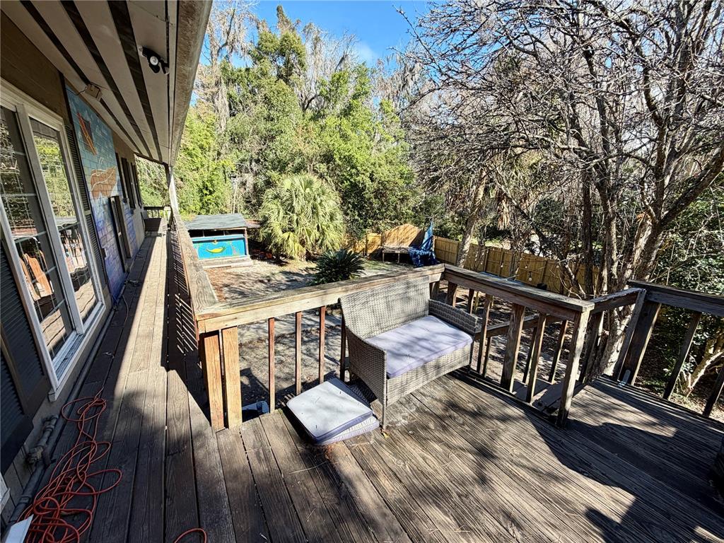 21 Southwest 23rd Terrace Gainesville, FL 32607 - Photo 8 of 23 a view of deck with furniture and trees