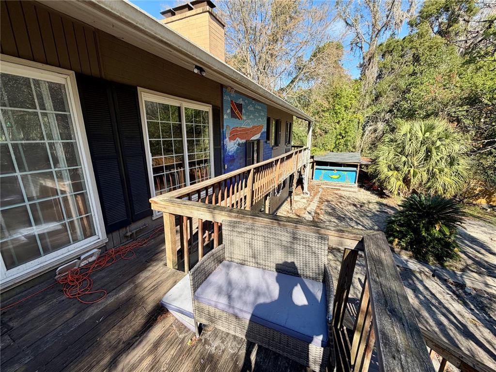 21 Southwest 23rd Terrace Gainesville, FL 32607 - Photo 9 of 23 a view of deck with table and chairs and wooden floor