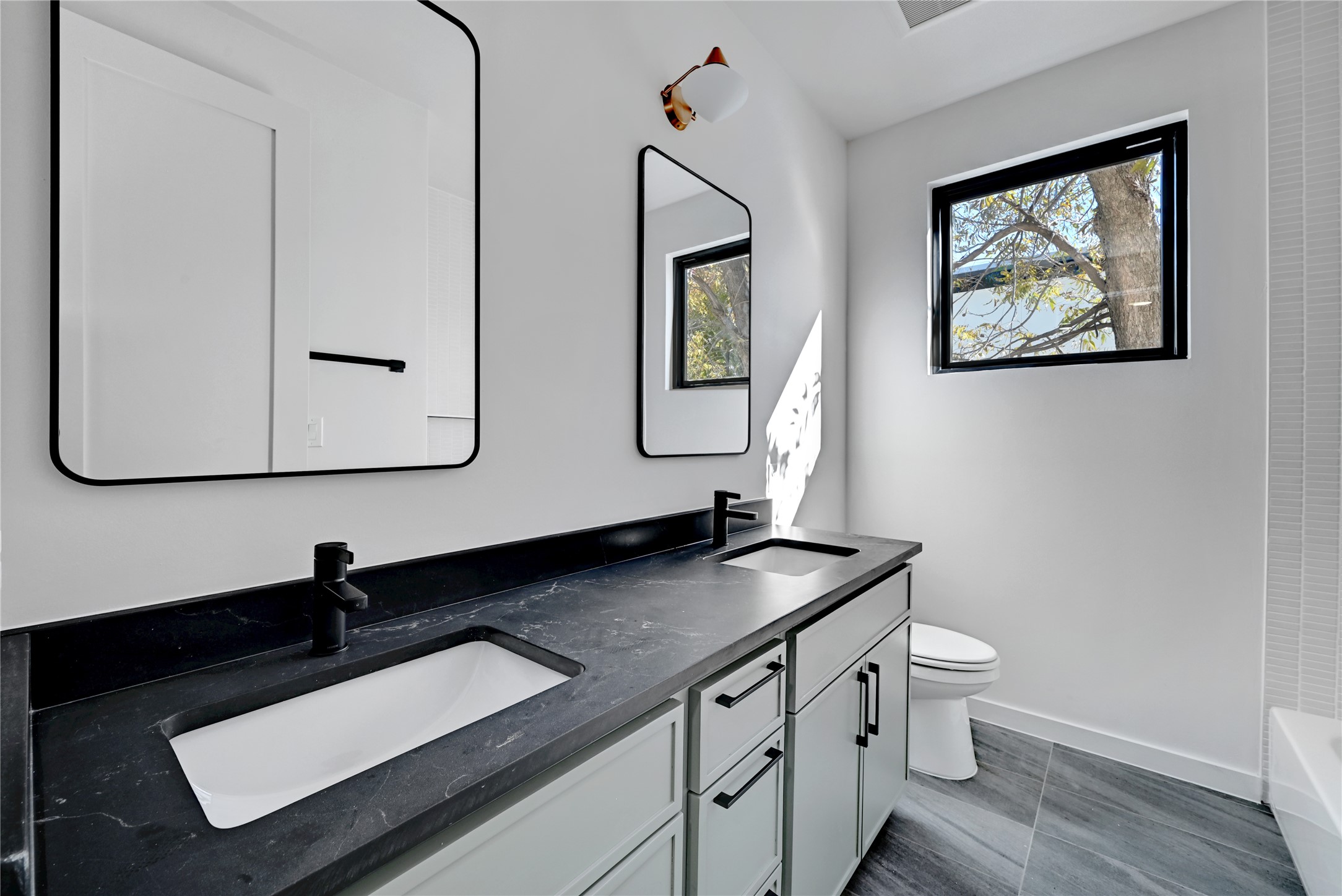 2717 Lyons Road, Unit 1 Austin, TX 78702 - Photo 24 of 34 Bathroom featuring double vanity and toilet