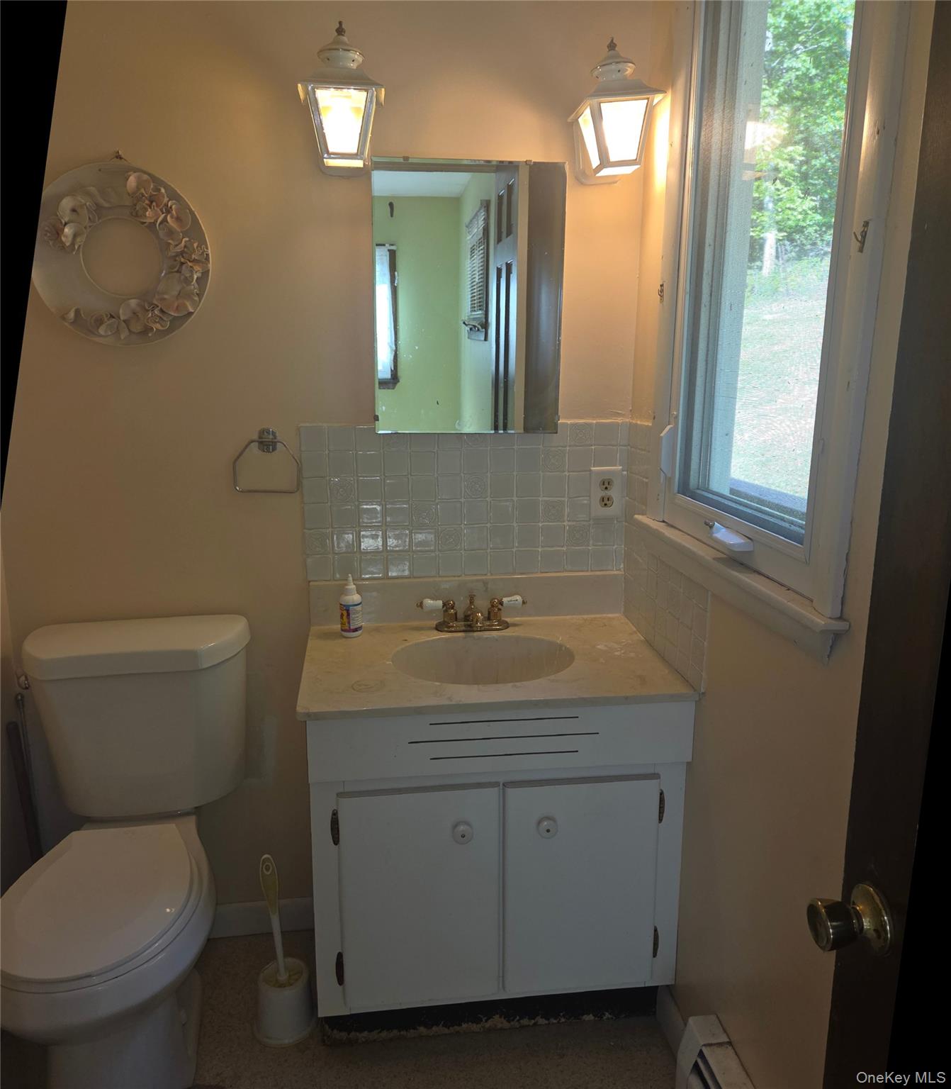 63 Otens Road Ellenville, NY 12428 - Photo 15 of 32 a bathroom with a toilet sink and mirror