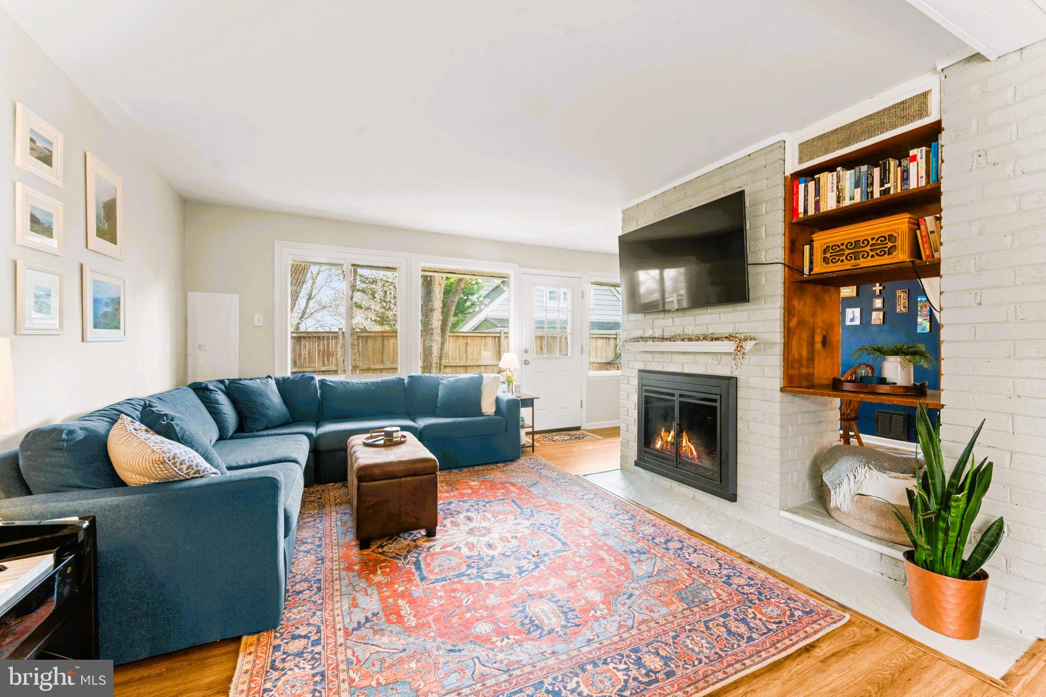 1806 Tilton Drive Silver Spring, MD 20902 - Photo 11 of 54 a living room with furniture a flat screen tv and a fireplace
