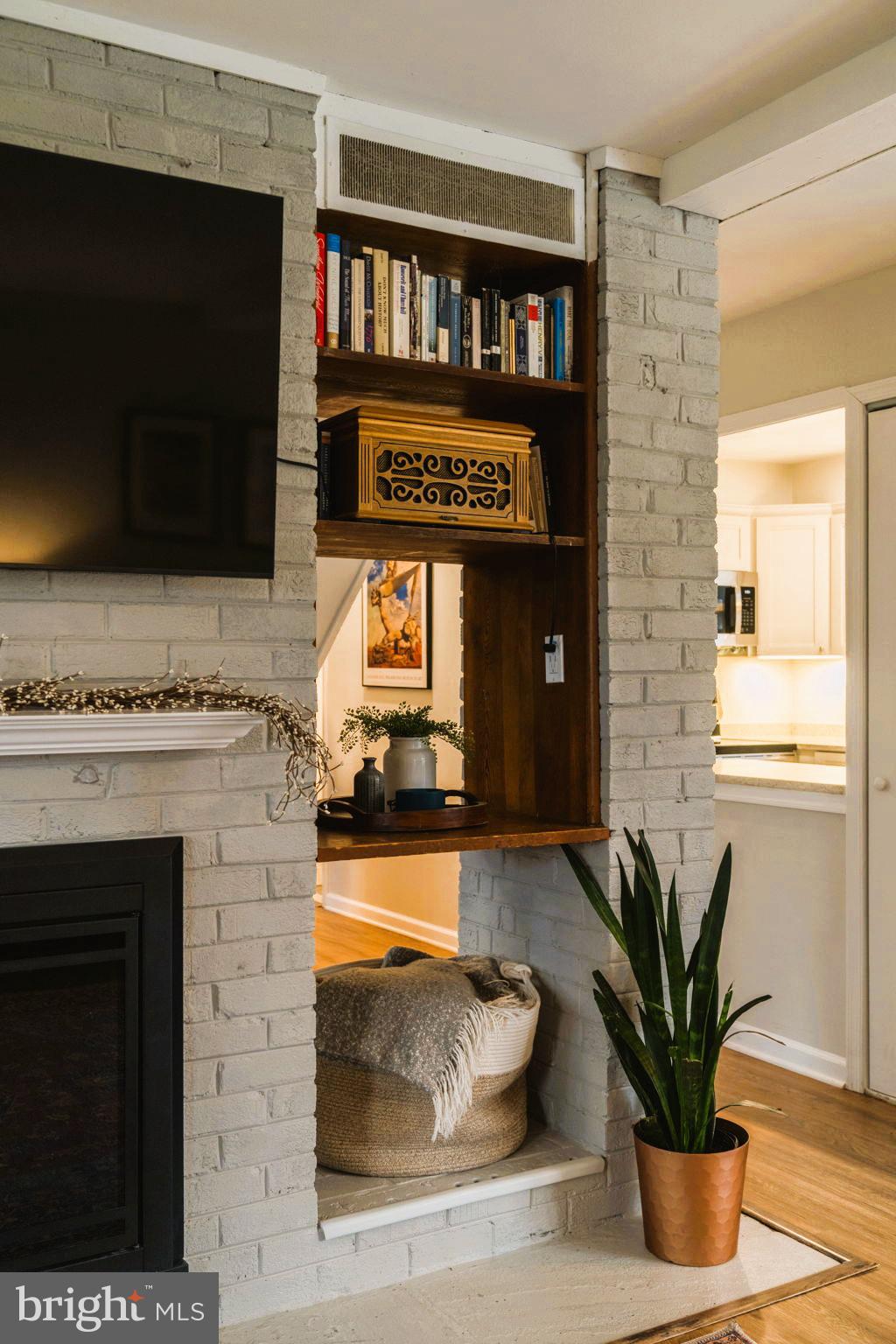 1806 Tilton Drive Silver Spring, MD 20902 - Photo 15 of 54 a living room with furniture a fireplace and a flat screen tv