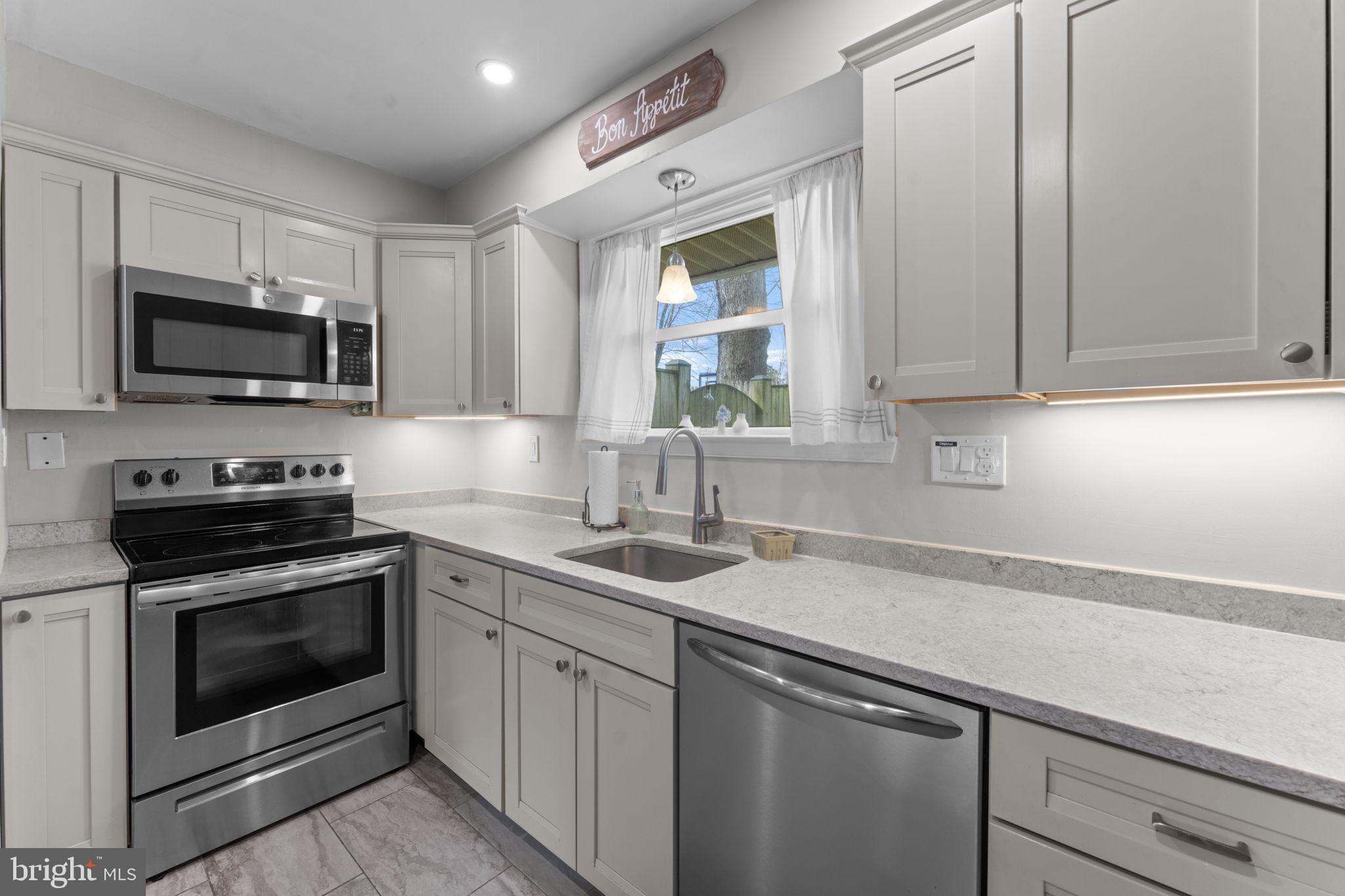 1806 Tilton Drive Silver Spring, MD 20902 - Photo 16 of 54 a kitchen with a sink stove and microwave