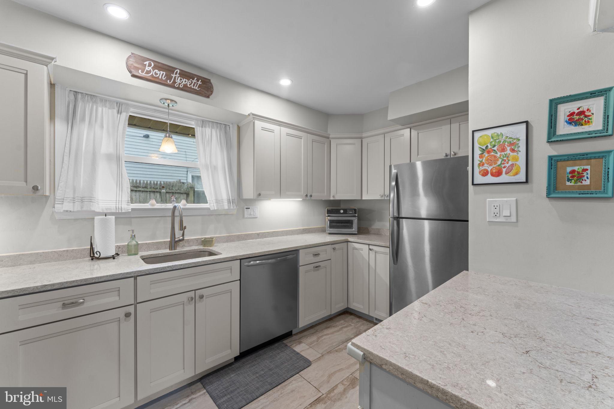 1806 Tilton Drive Silver Spring, MD 20902 - Photo 17 of 54 a kitchen with a sink refrigerator and cabinets