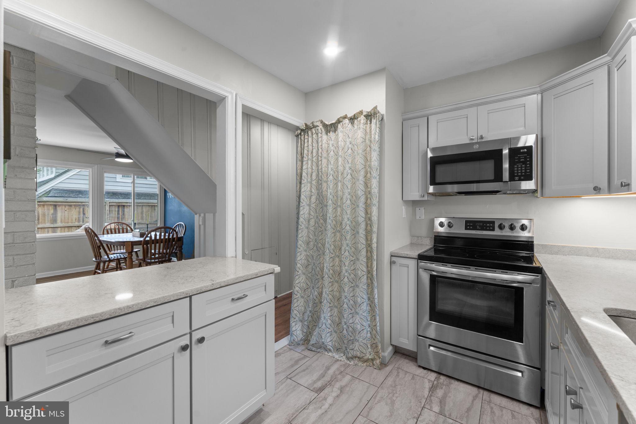 1806 Tilton Drive Silver Spring, MD 20902 - Photo 18 of 54 a kitchen with a stove and a microwave