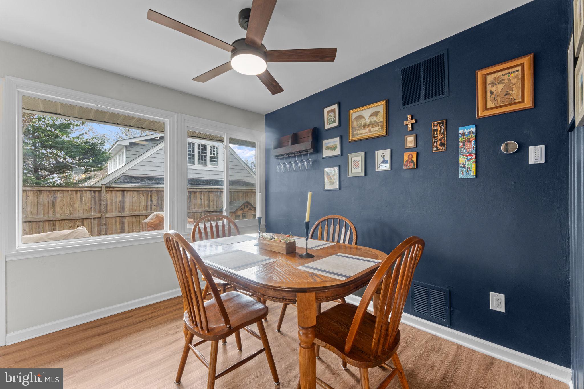 1806 Tilton Drive Silver Spring, MD 20902 - Photo 24 of 54 a view of a dining room with furniture large window and wooden floor