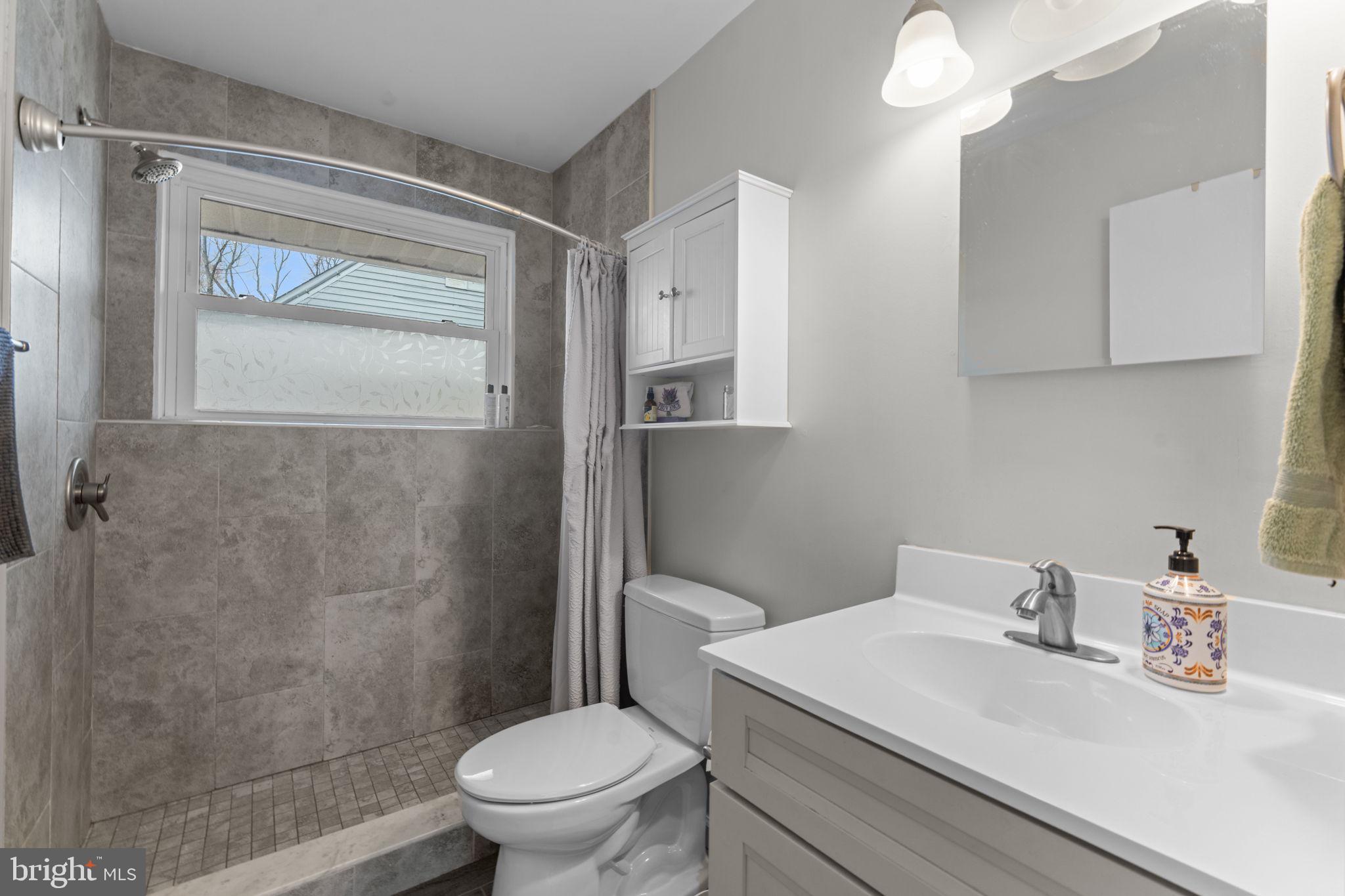 1806 Tilton Drive Silver Spring, MD 20902 - Photo 32 of 54 a bathroom with a sink a toilet and shower