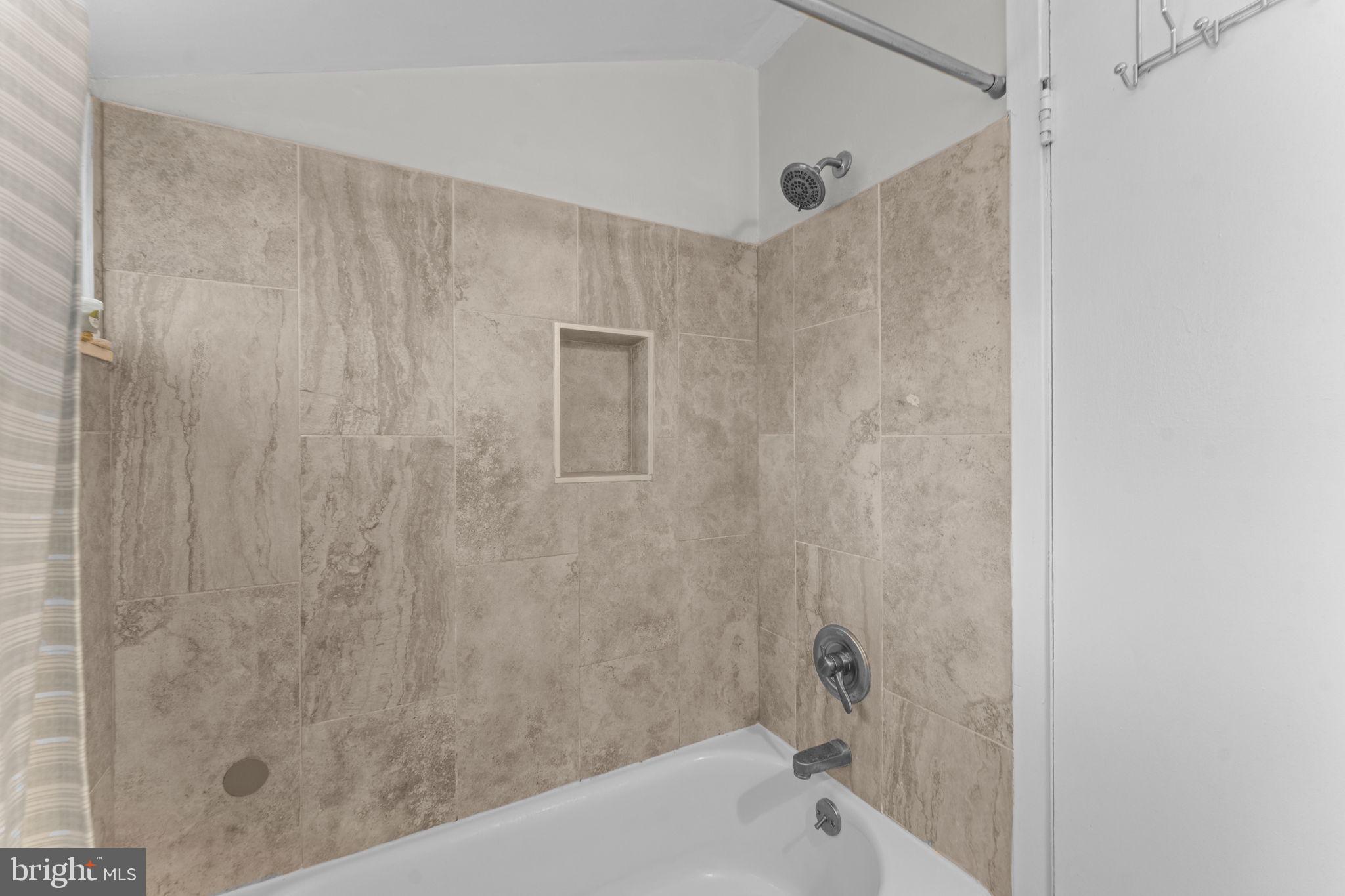 1806 Tilton Drive Silver Spring, MD 20902 - Photo 40 of 54 a bathroom with a bathtub and shower