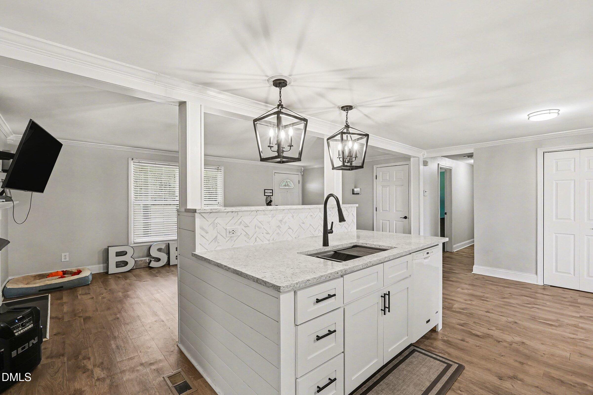 774 Abbott Road Henderson, NC 27537 - Photo 12 of 31 a kitchen with kitchen island granite countertop a sink stainless steel appliances and cabinets
