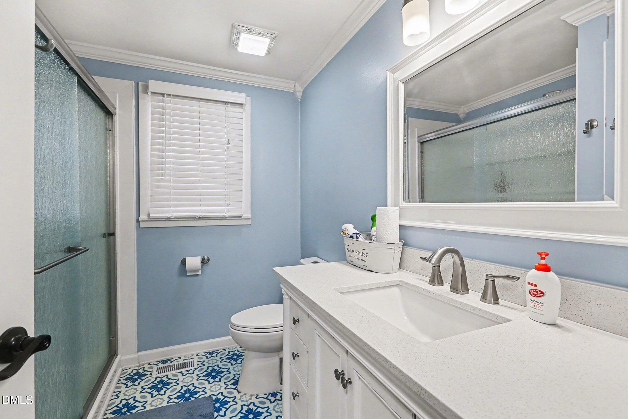 774 Abbott Road Henderson, NC 27537 - Photo 18 of 31 a bathroom with a sink toilet and a mirror