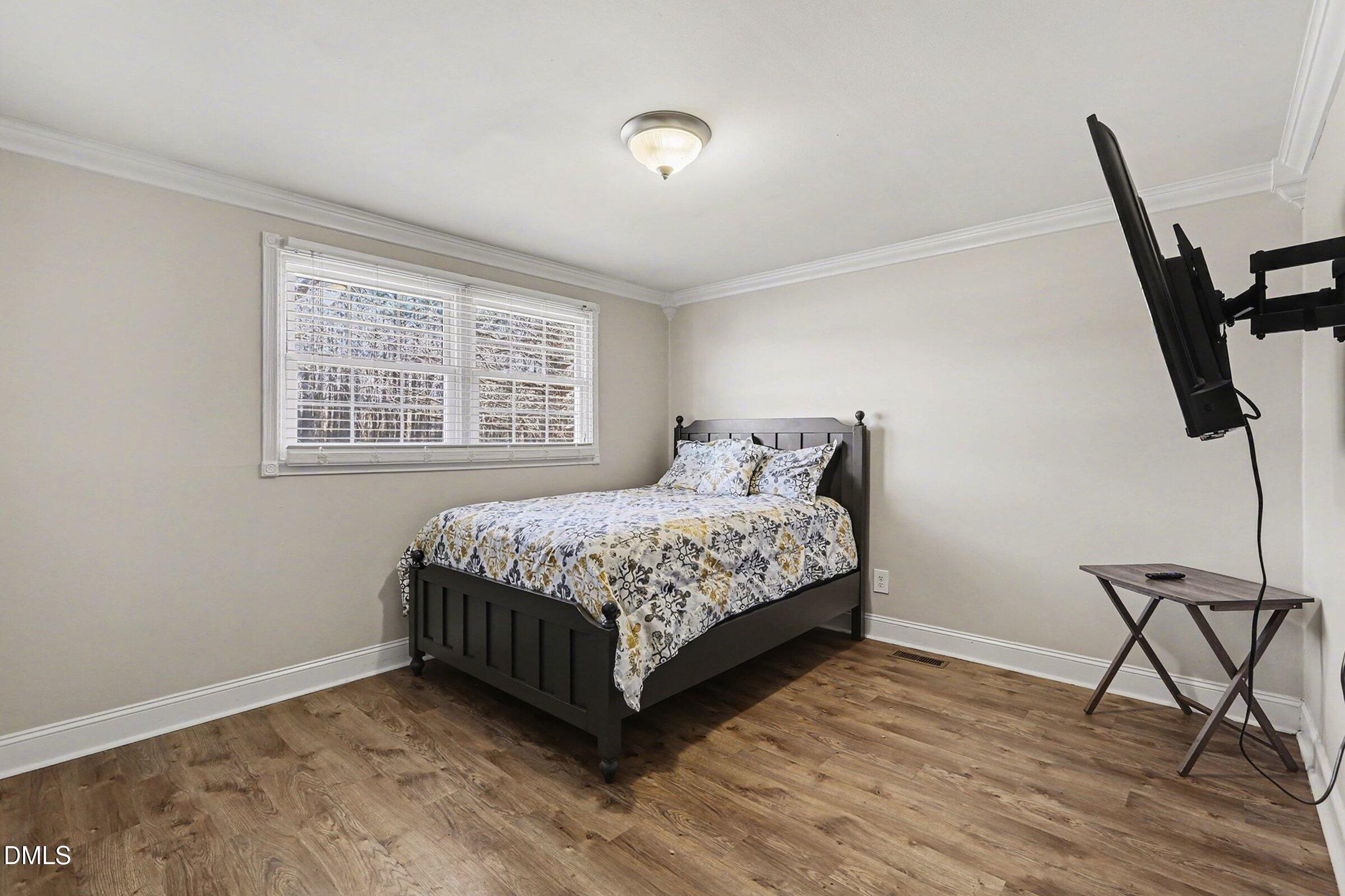 774 Abbott Road Henderson, NC 27537 - Photo 19 of 31 a bedroom with a bed a desk and chair