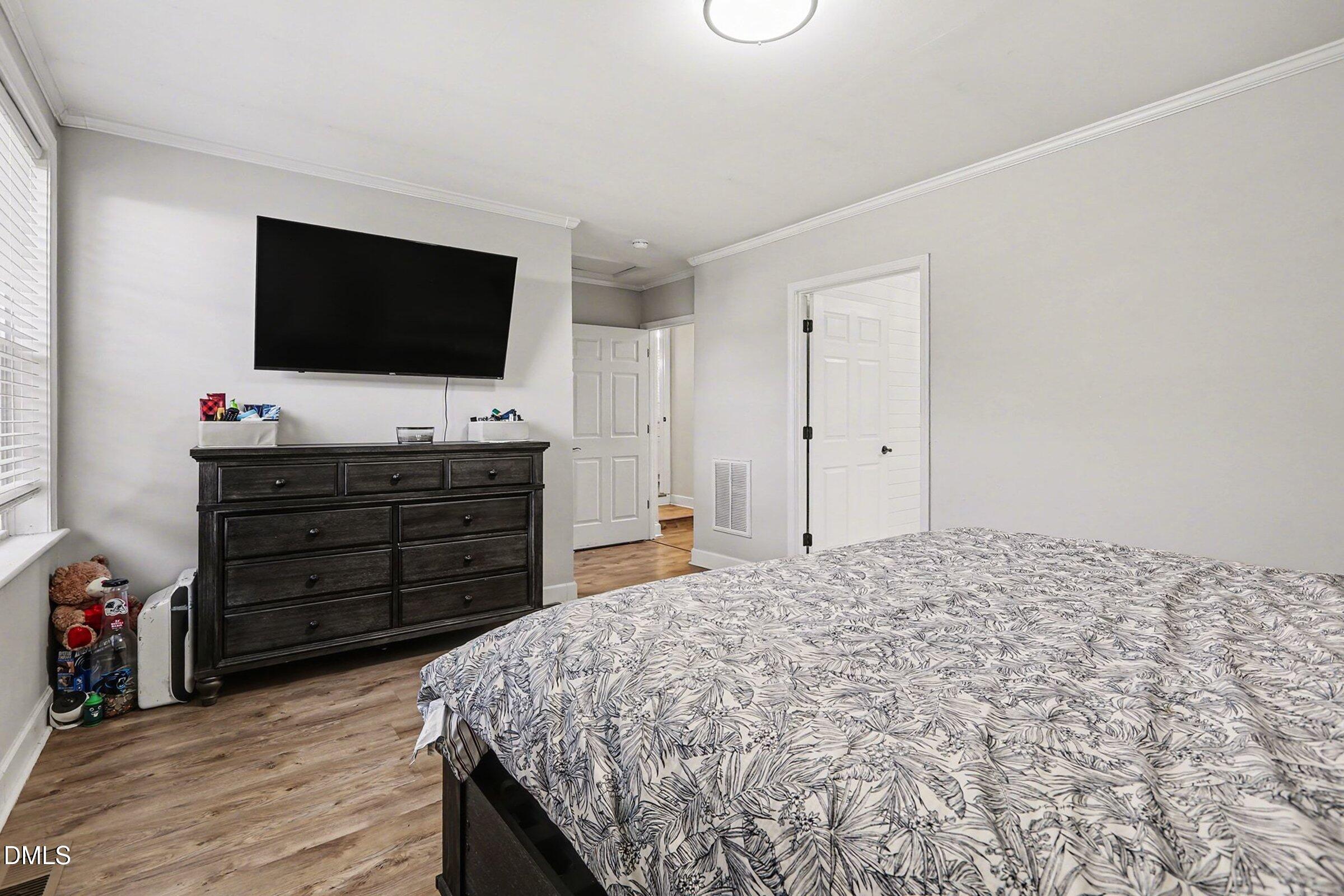 774 Abbott Road Henderson, NC 27537 - Photo 25 of 31 a bedroom with a bed and a flat screen tv